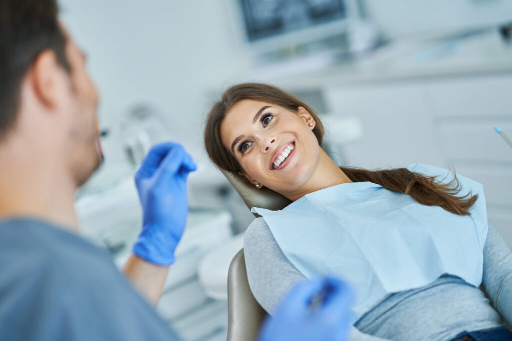 Male dentist and woman in dental clinic