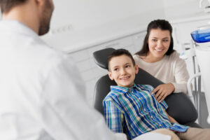 Parent and child visiting the dentist for a back-to-school checkup