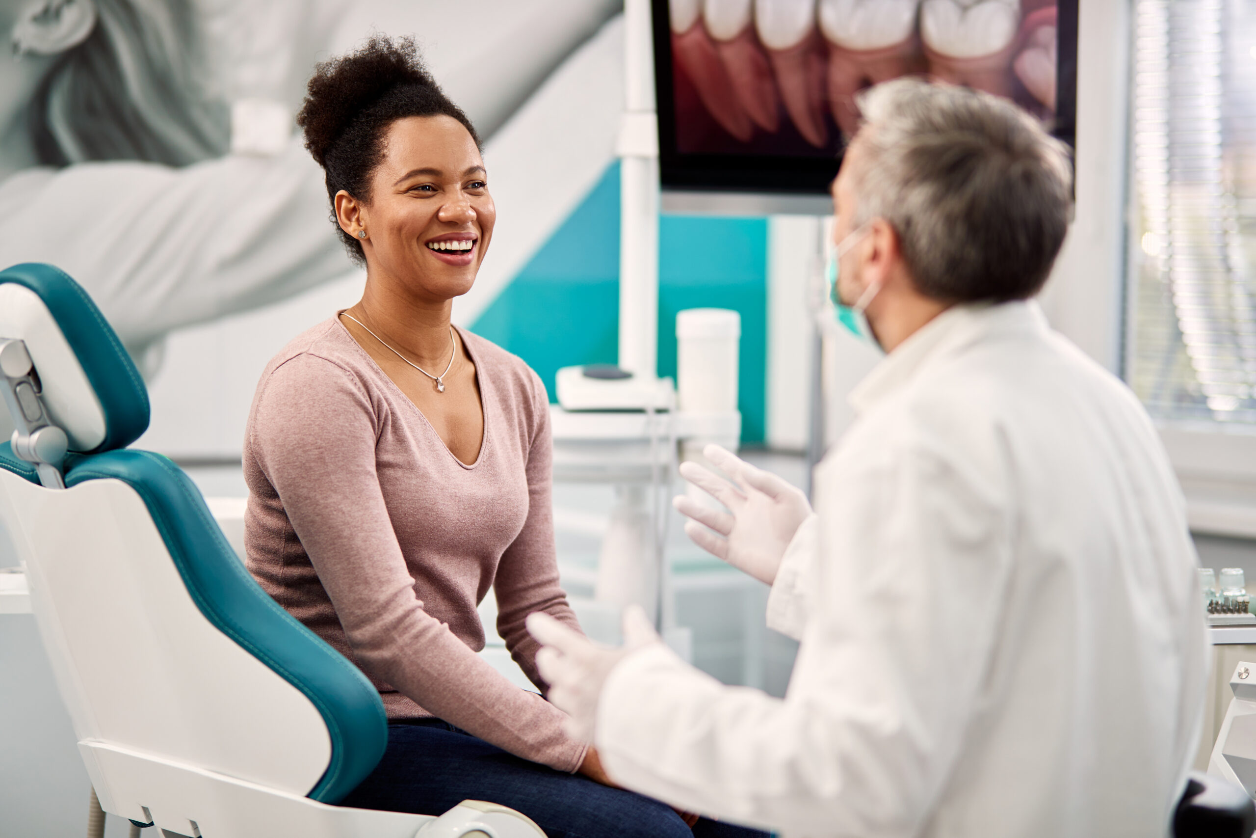 Patient smiling with her dentist during a composite bonding consultation at Satilla Family Smiles